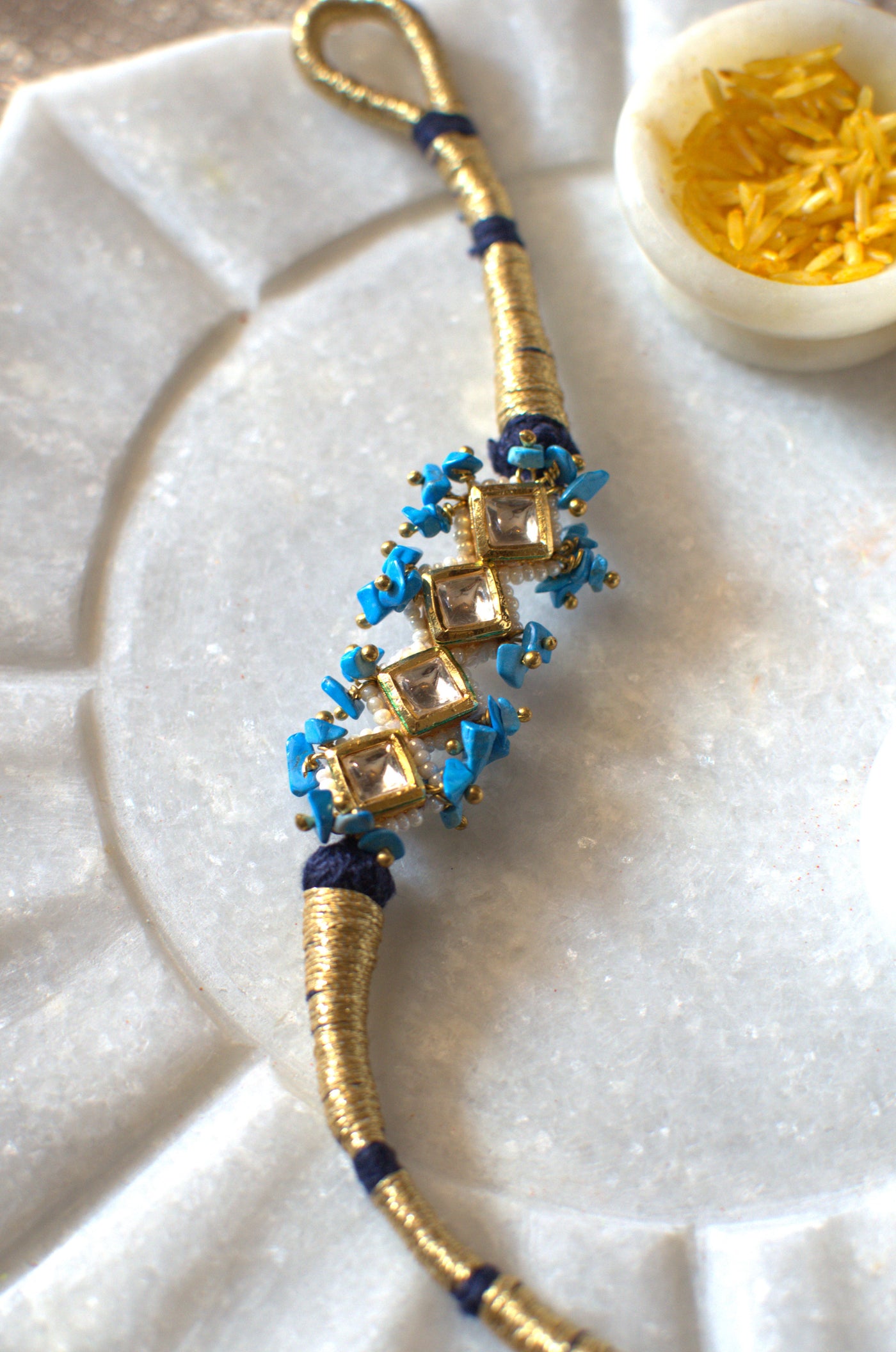 Turquoise and blue polki rakhi bracelet